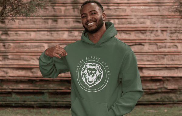 A man wearing a green hoodie with a bear logo.