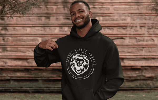 A man wearing a black hoodie with a bear logo.