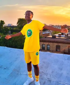 A person standing on top of a ramp wearing yellow shorts.