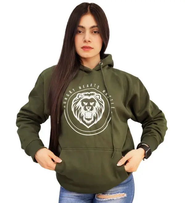 A woman wearing a green hoodie with a lion logo on the front.