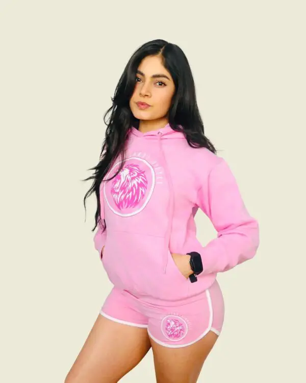 Woman in pink hoodie and shorts.