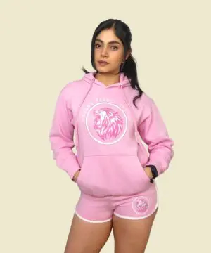 Woman in pink hoodie and shorts set.