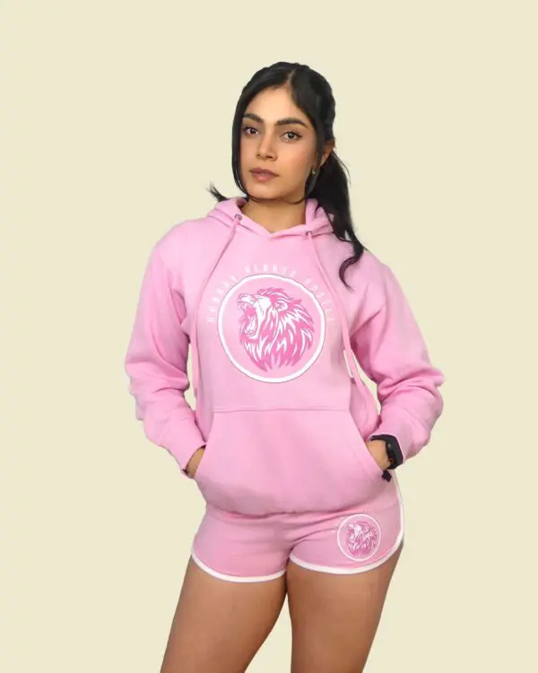 Woman in pink hoodie and shorts set.