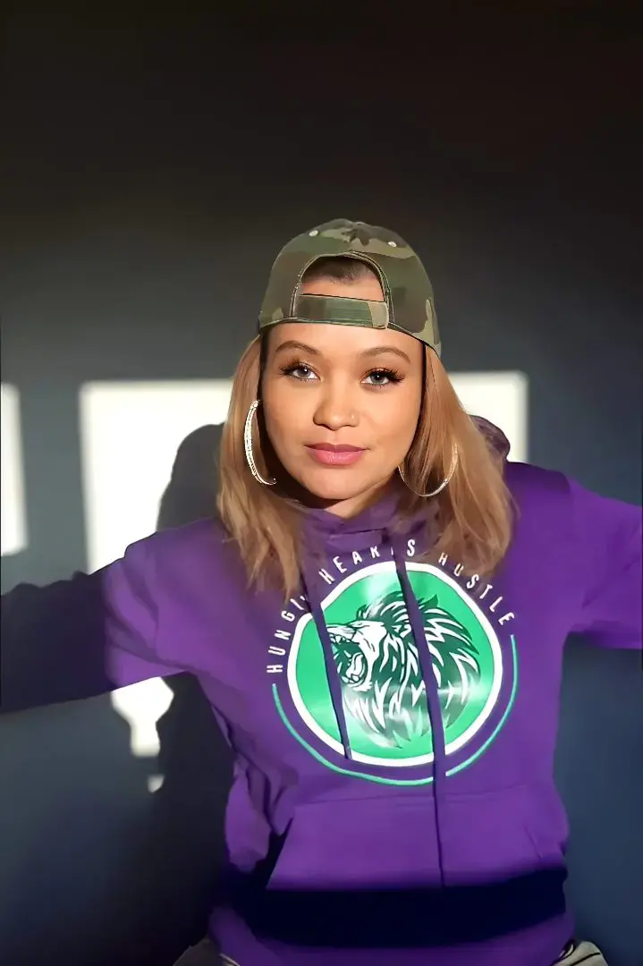 Woman in purple hoodie and camo cap