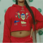 A woman in red is wearing a crop top and shorts.
