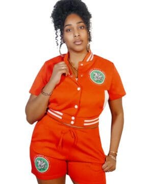 A woman in an orange outfit posing for the camera.
