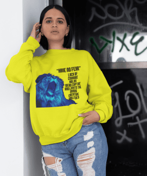 A woman wearing jeans and a yellow sweatshirt.