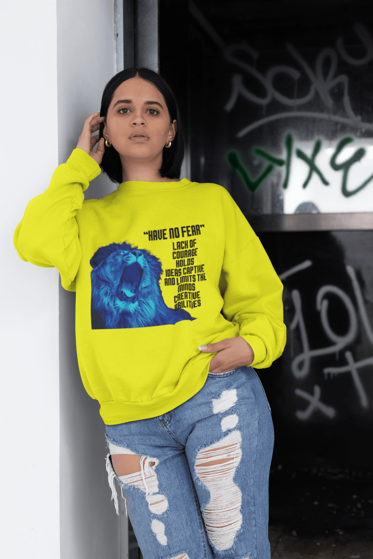 A woman wearing jeans and a yellow sweatshirt.