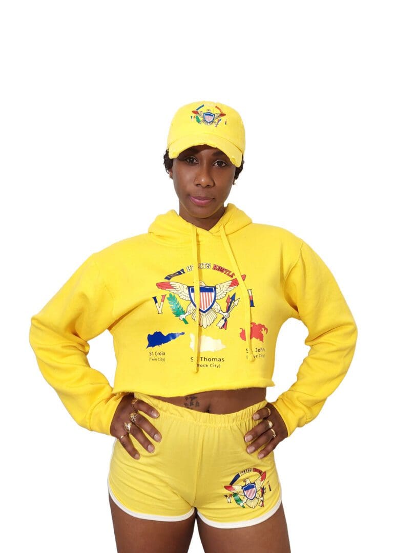 A woman in yellow outfit and hat posing for the camera.