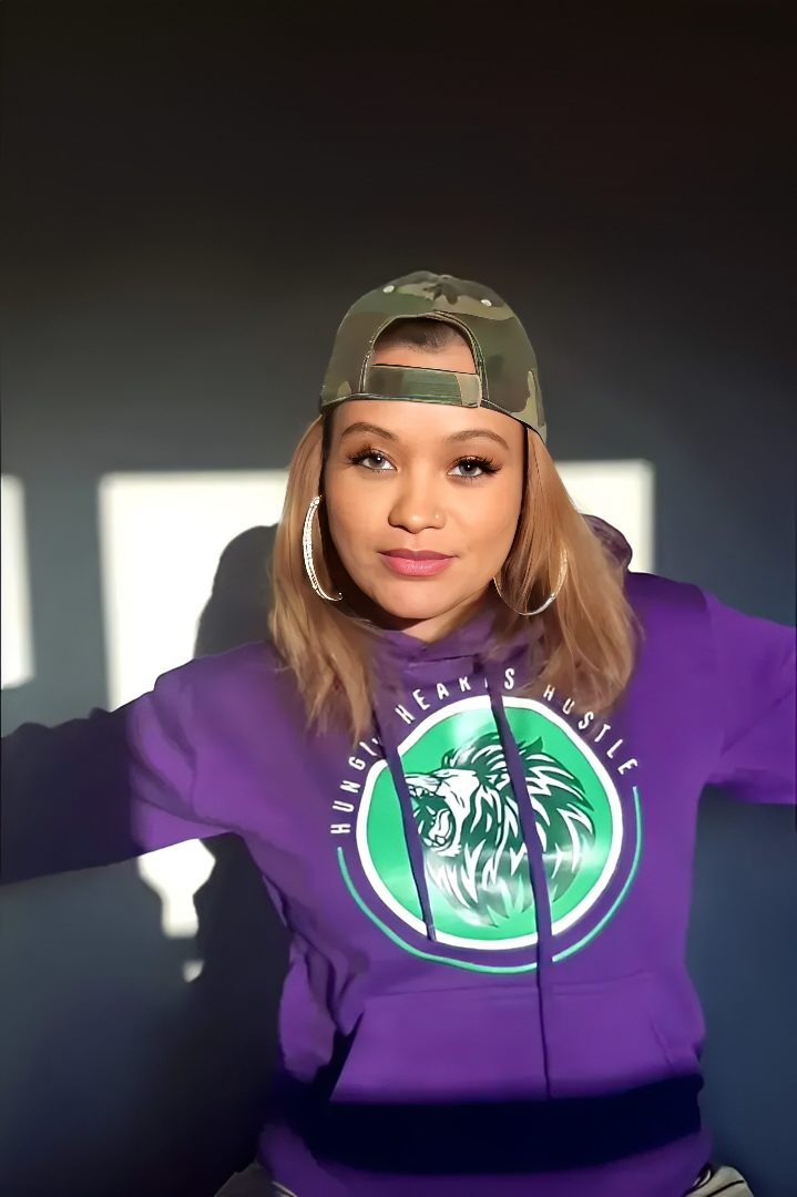 Woman in purple hoodie and camo cap